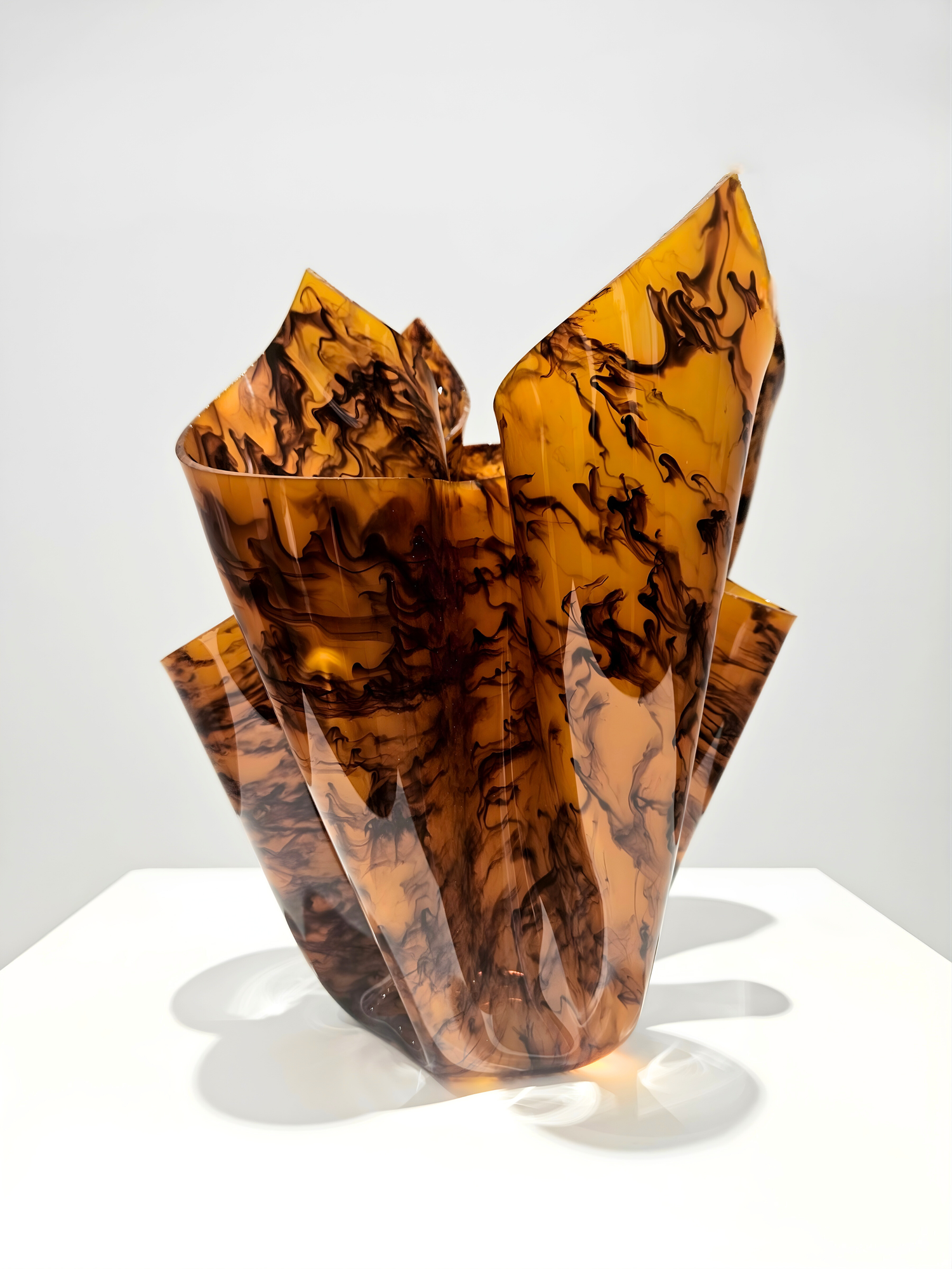 Amber Acrylic Glass Sculpture by Logan Bow on a white plinth